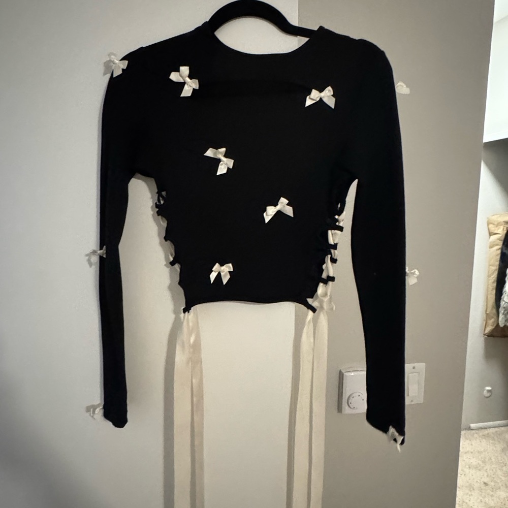 Elegant Black Top with White Bow Accents